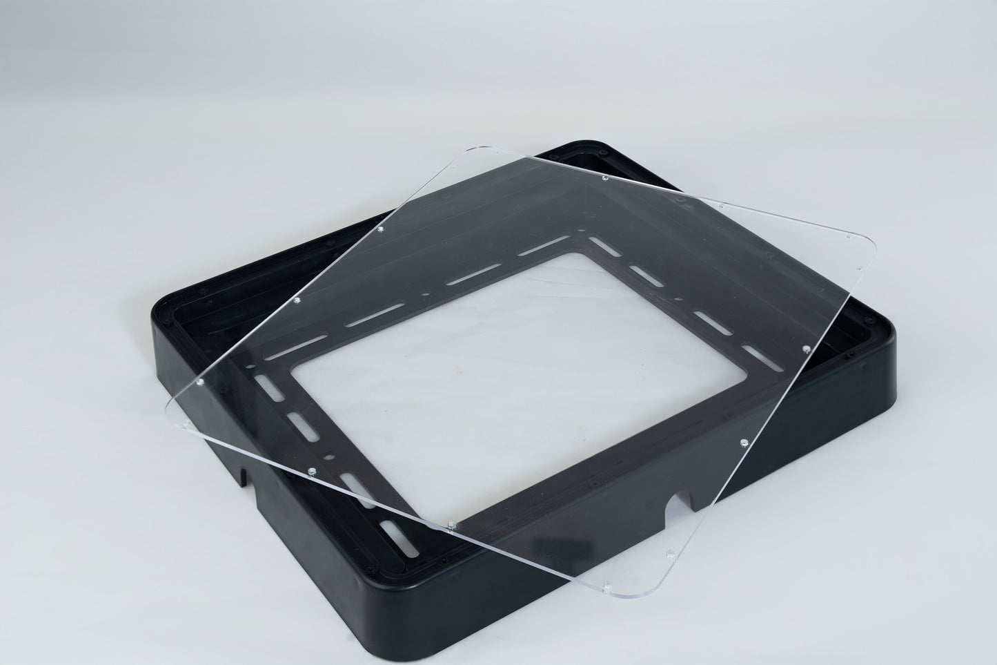 Clear acrylic sheet on a black ASA frame against a white background